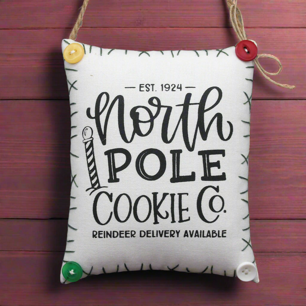 Fabric mini pillow sign with 'North Pole Cookie Co.' text