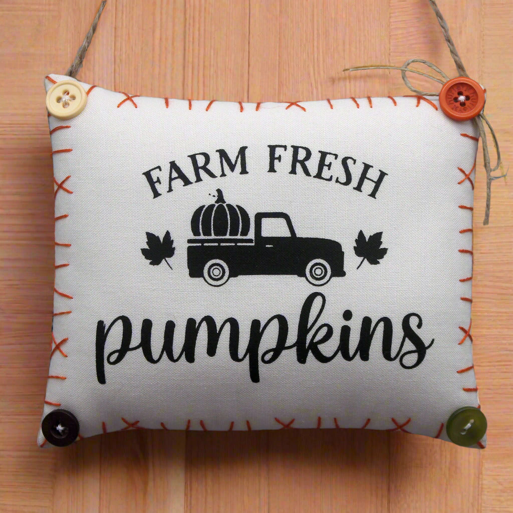 Decorative mini pillow sign with 'Farm Fresh Pumpkins' text and truck graphic
