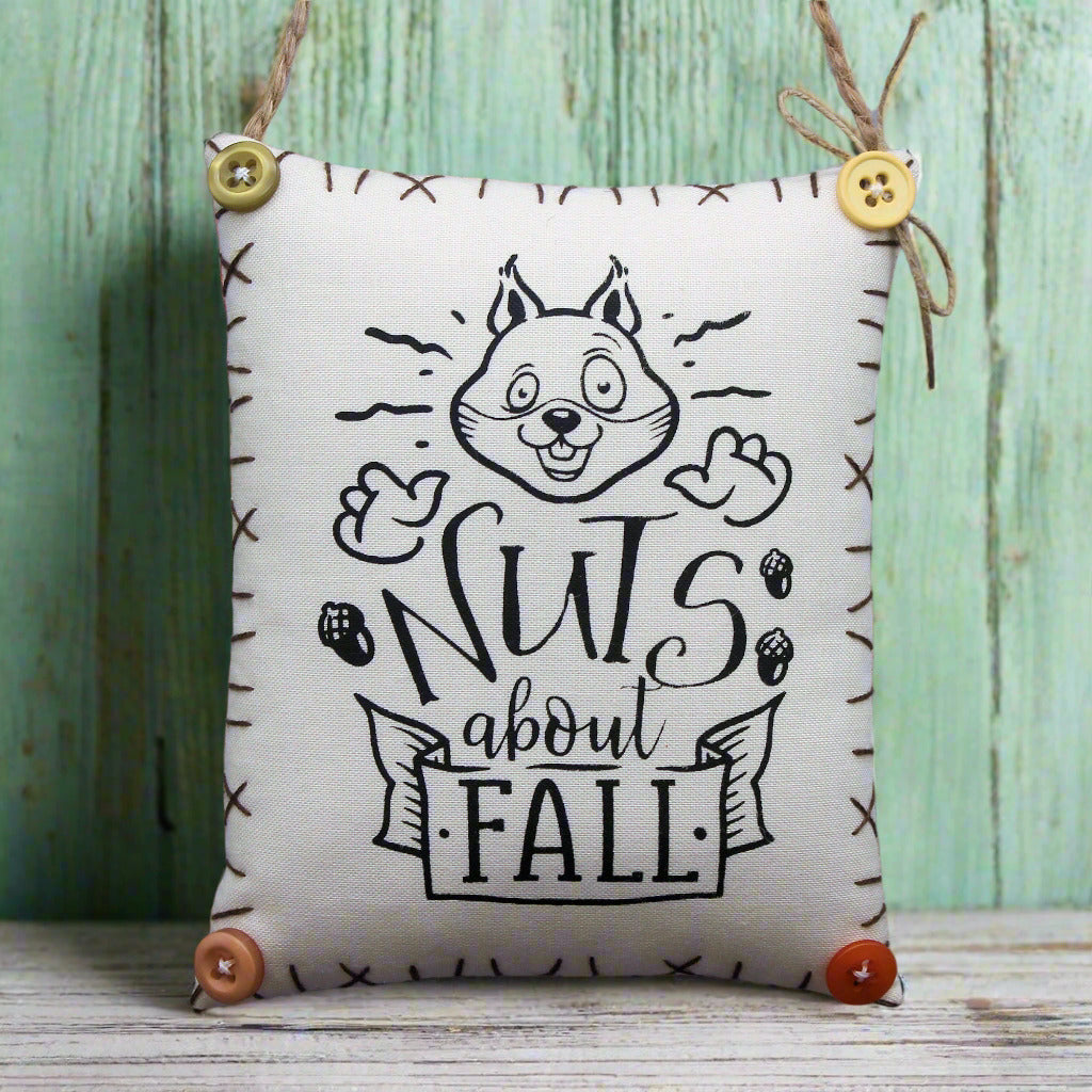 Decorative mini pillow sign with an image of an enthusiastic squirrel who is 'nuts about fall'