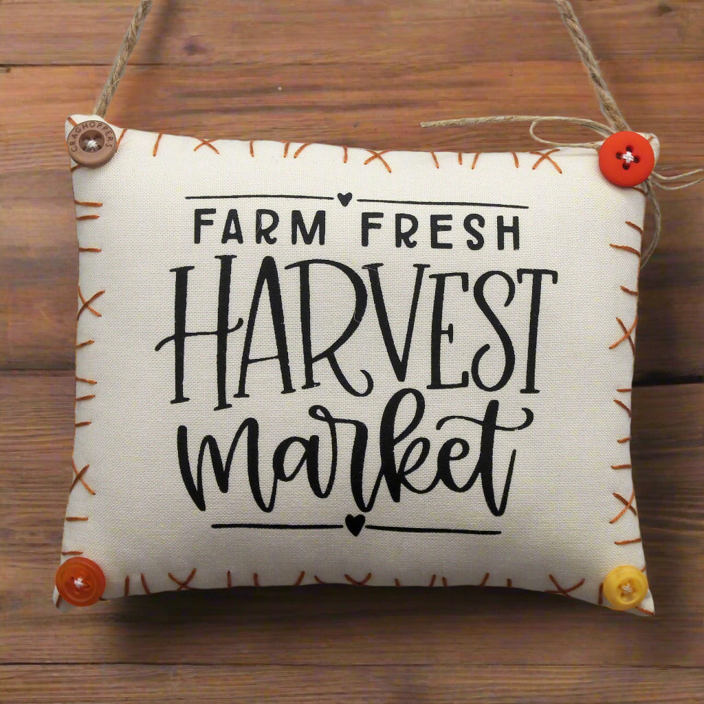Decorative mini pillow sign with 'Farm Fresh Harvest Market' text on a wooden background
