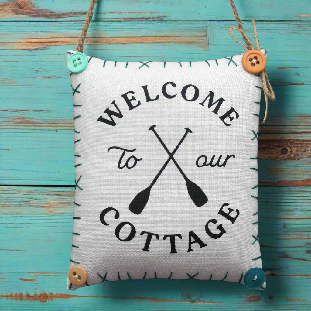 Fabric sign with 'Welcome to our Cottage' text and oar design