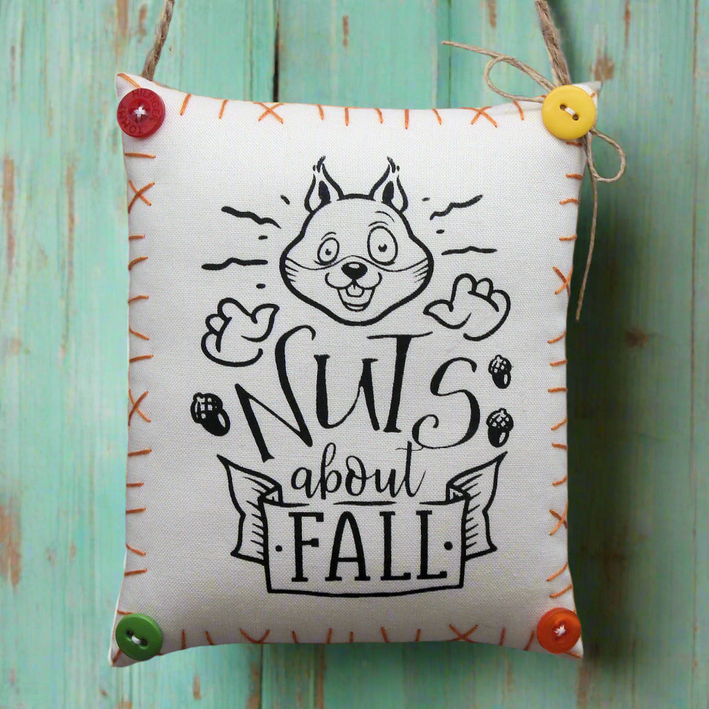 Fabric mini pillow sign with a squirrel design and 'Nuts about Fall' text