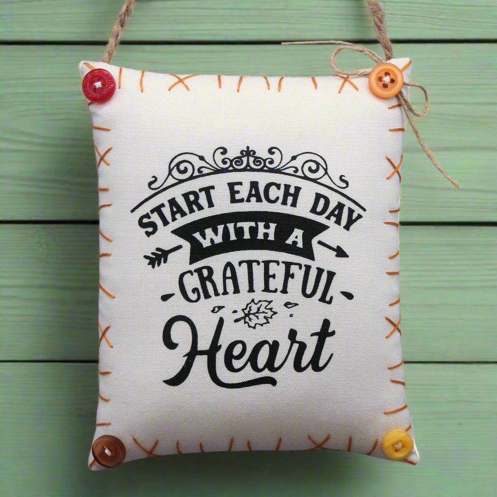 Decorative mini pillow sign with the quote 'start each day with a grateful heart'