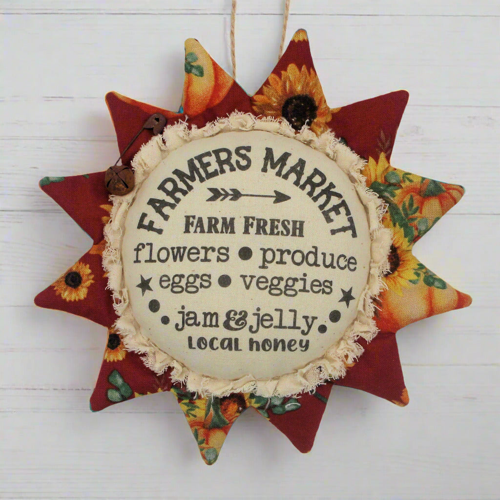 Primitive fabric sunflower ornament with an advertisement for a farmers market