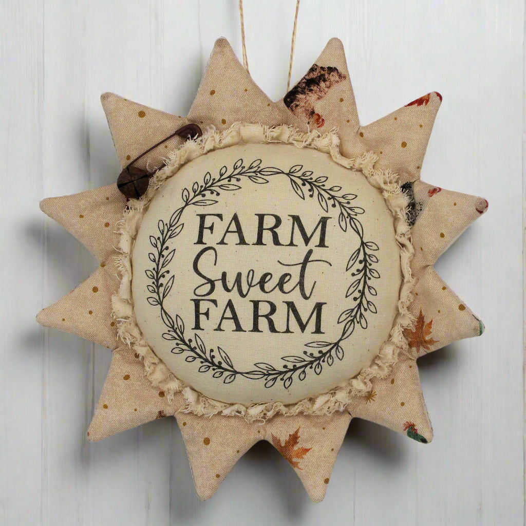 Decorative fabric sunflower sign with 'Farm Sweet Farm' text on a white background