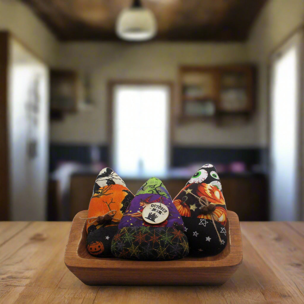 Set of three candy corn bowl fillers made from Halloween print fabrics