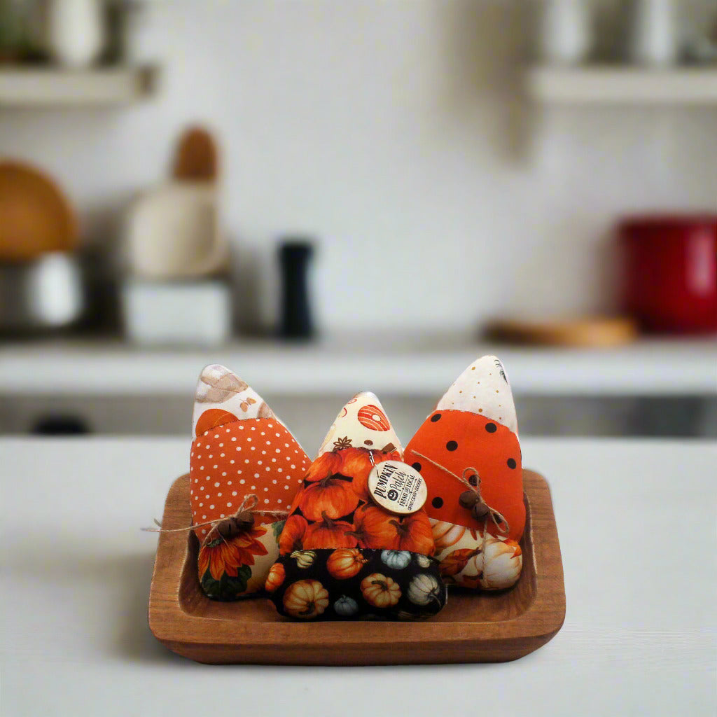 Set of three candy corn bowl fillers in a kitchen setting