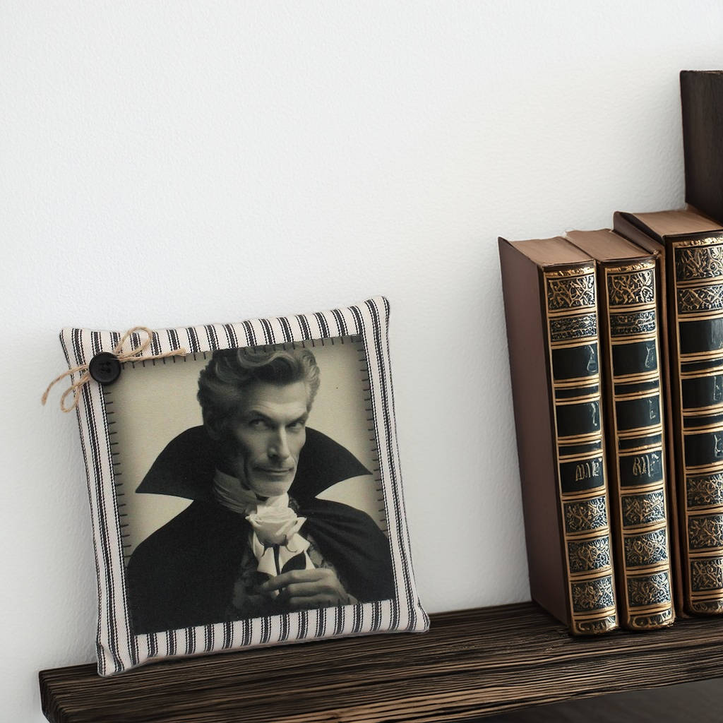 Decorative pillow with a portrait on a shelf with books