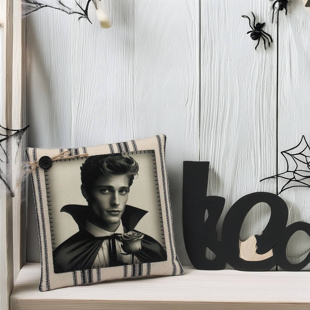 Decorative pillow with a portrait on a shelf with Halloween decorations.