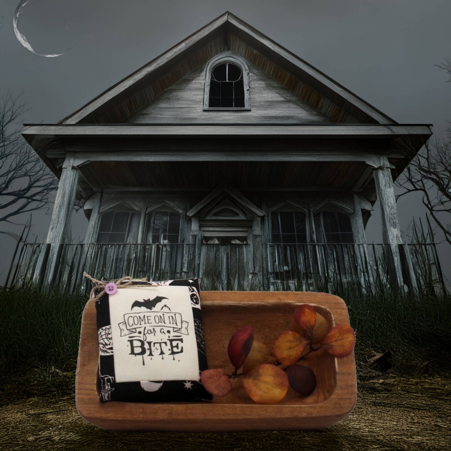 Wooden bowl with a mini pillow bowl filler sign in front of an old house with a moonlit sky.