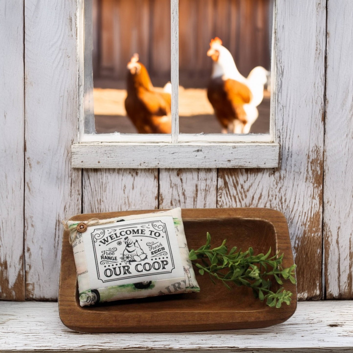 Mini pillow bowl filler sign with 'Welcome to Our Coop' text on a wooden tray, with chickens visible through a window in the background.