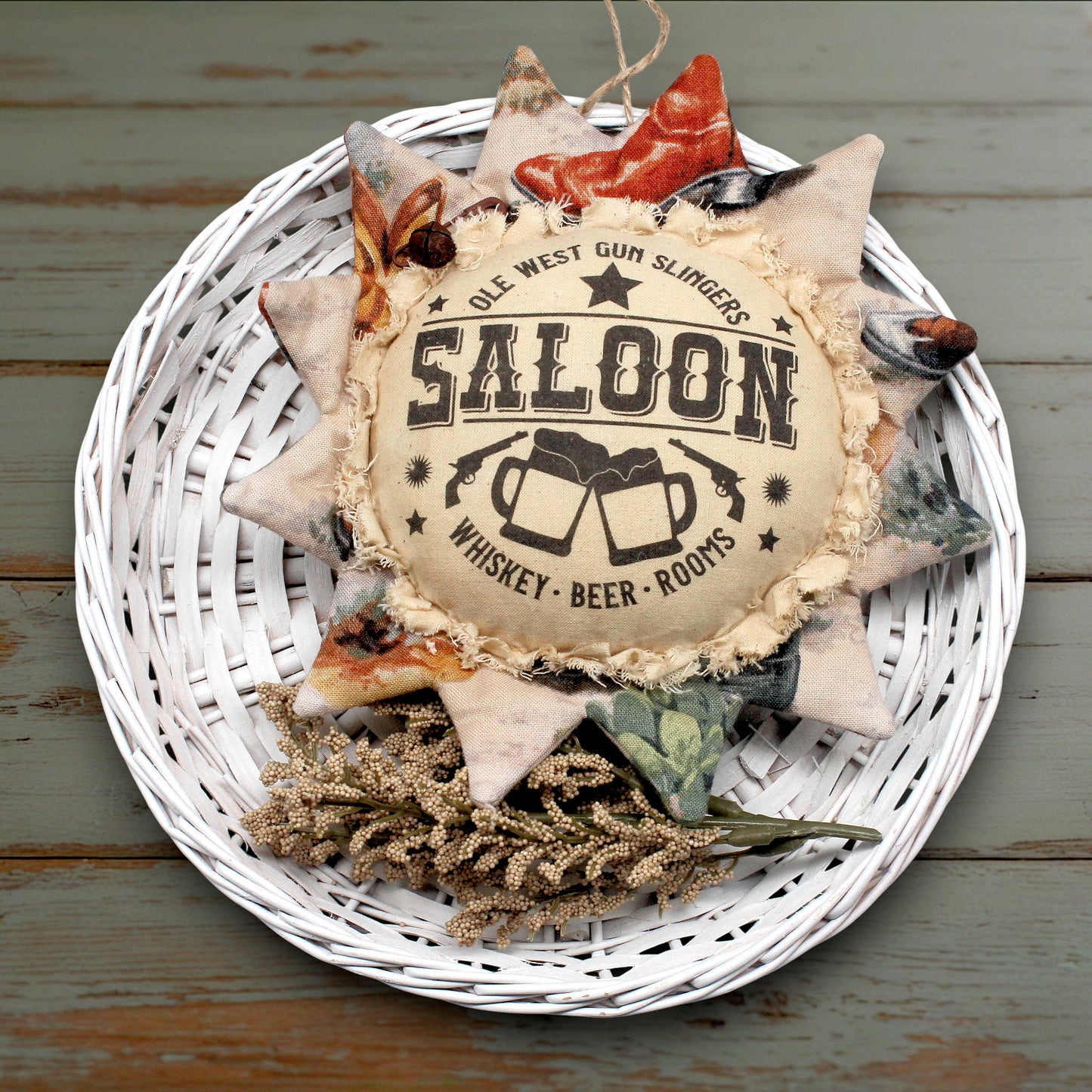 Primitive fabric sunflower ornament with an advertisement for a western saloon