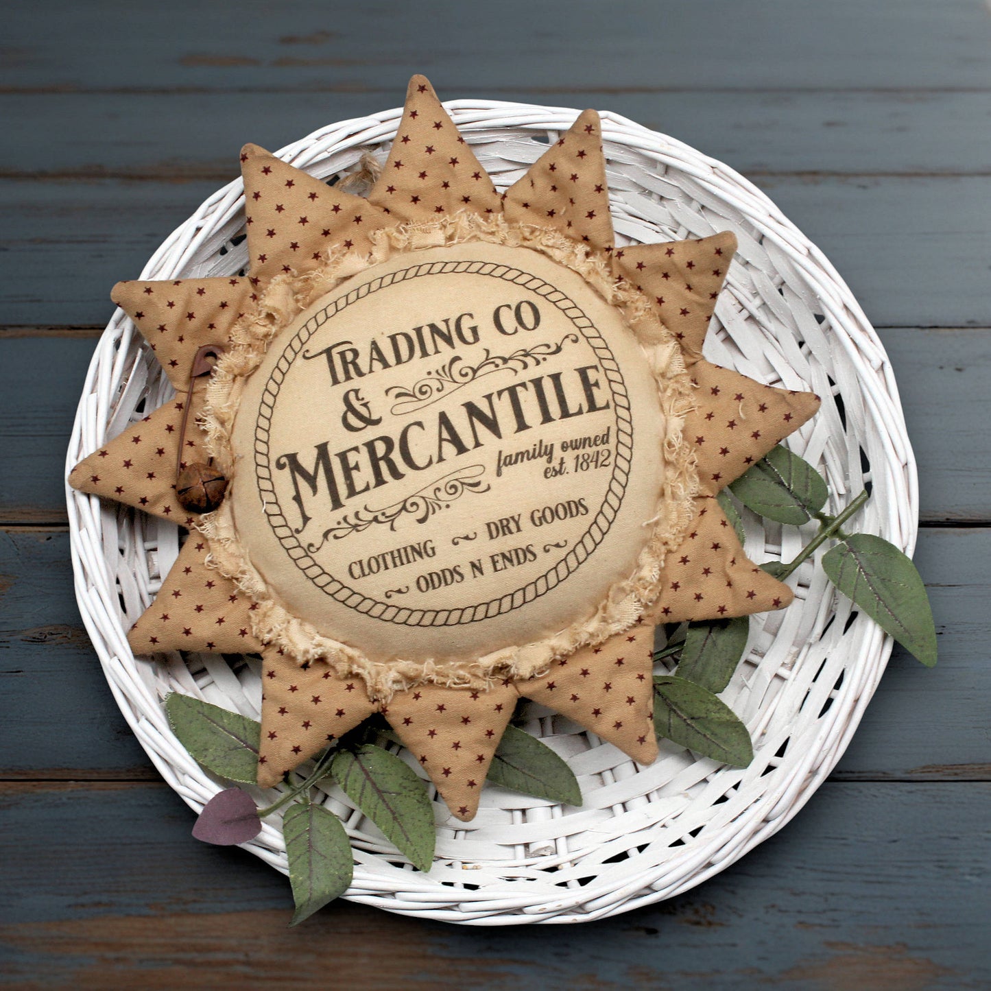 Primitive sunflower ornament with an advertisement for a trading company and mercantile