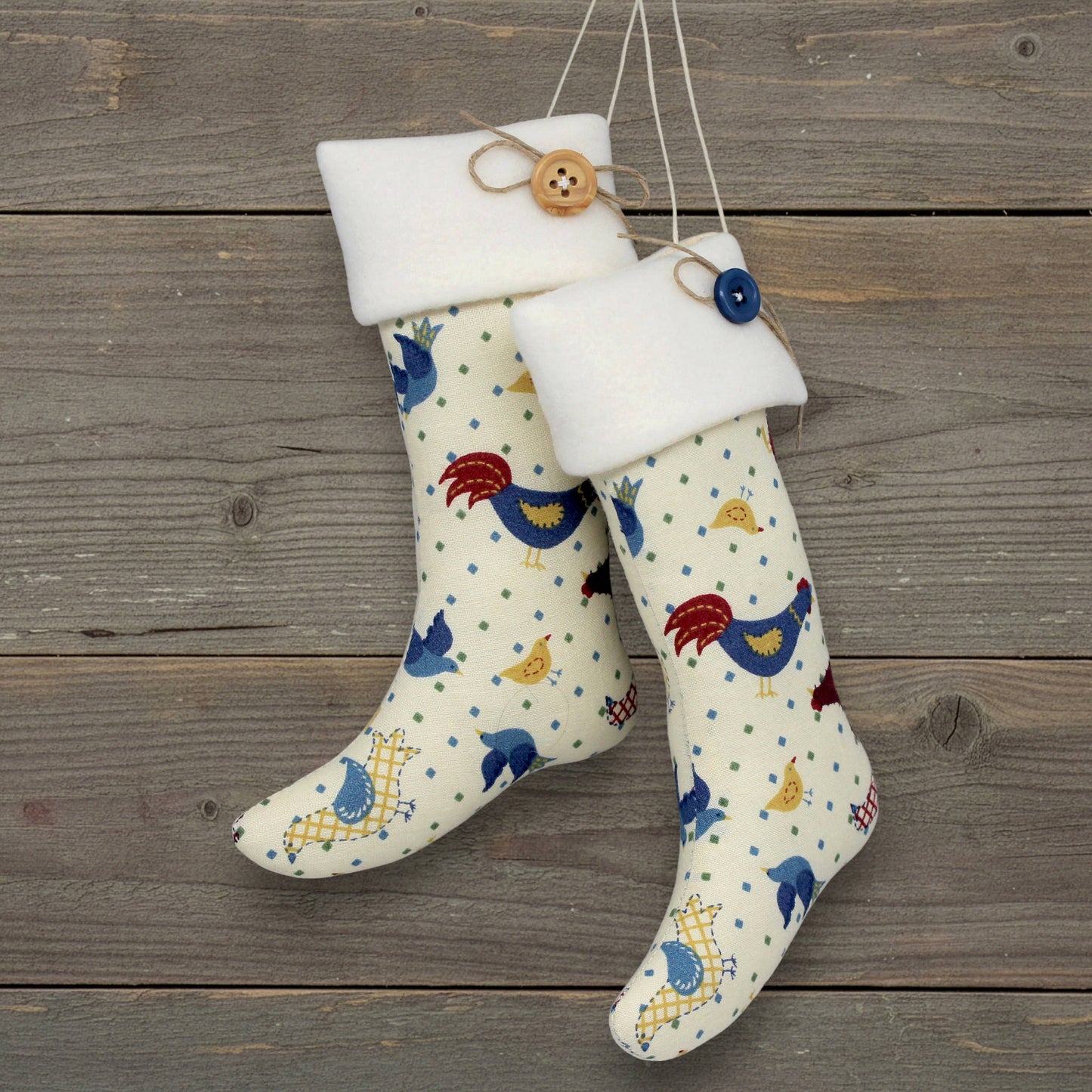 Decorative stocking ornaments with chicken pattern hanging on a wooden surface