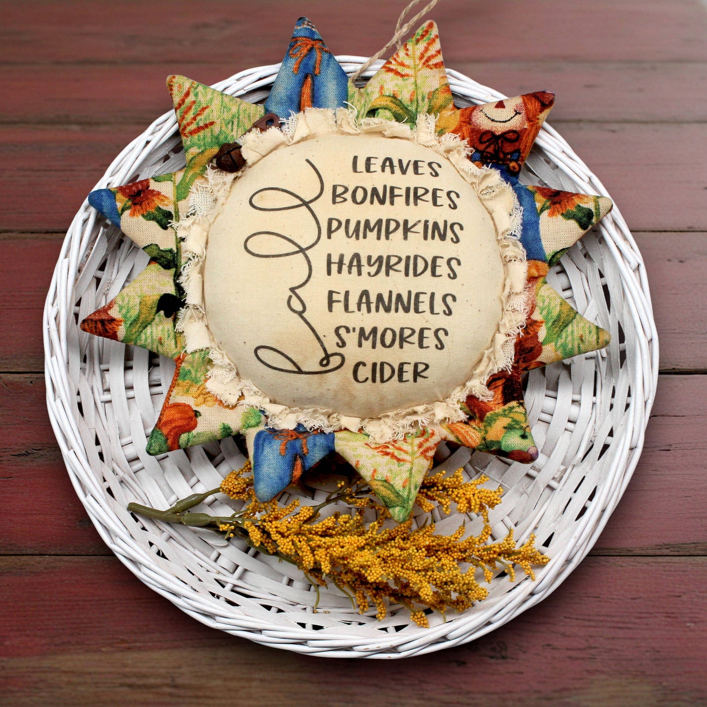 Primitive sunflower ornament with a list of fall favorites printed on the center