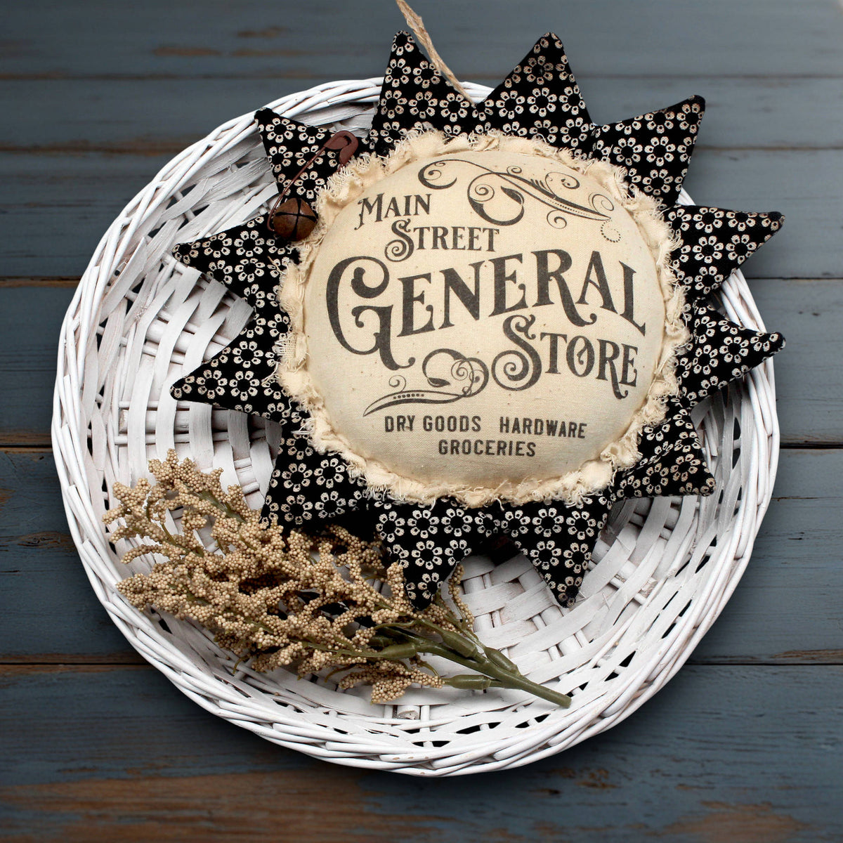 Primitive fabric sunflower ornament with an advertisement for the Main Street General Store