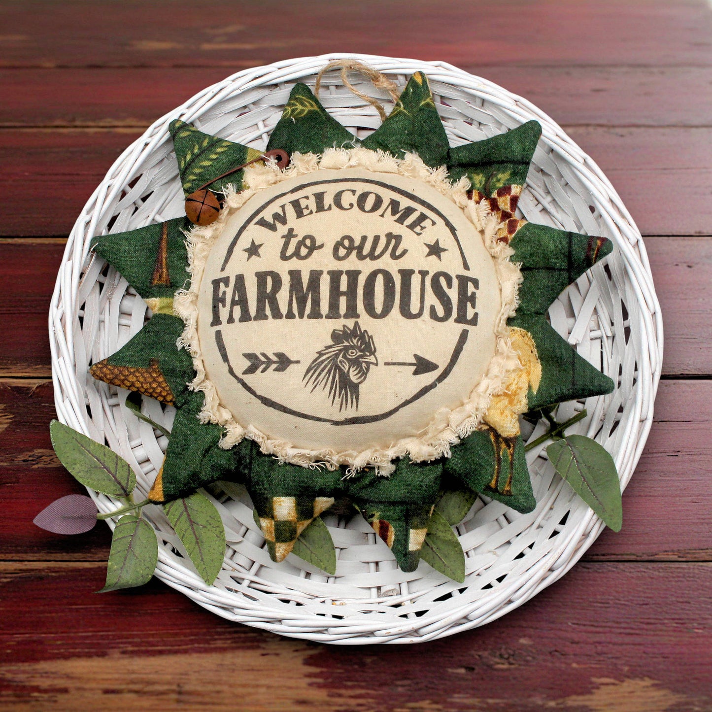 Decorative sunflower ornament with 'Welcome to our Farmhouse' text on a wooden background