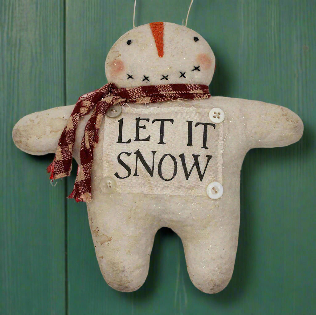 Handmade primitive snowman ornament with a let it snow sign on his front