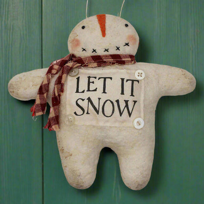 Handmade primitive snowman ornament with a let it snow sign on his front