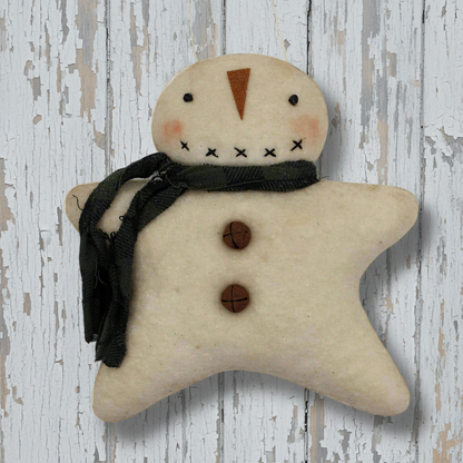 Star-shaped snowman ornament with buttons and a scarf on a wooden background