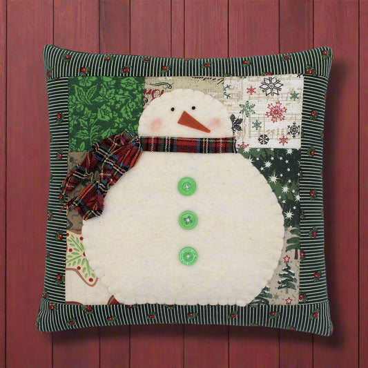 Snowman pillow with a patchwork background