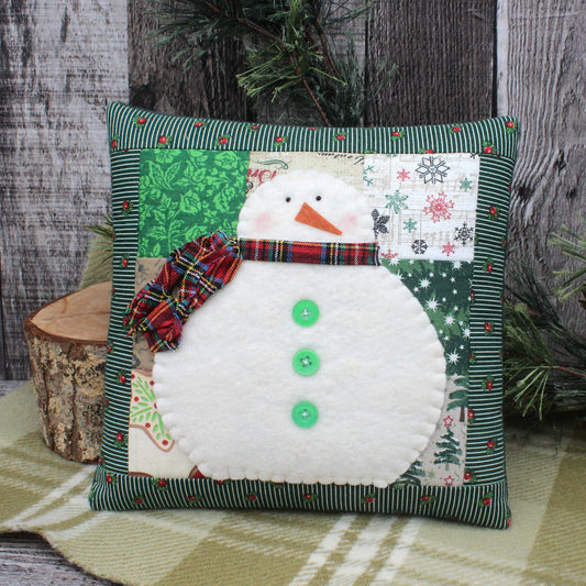 Decorative mini pillow with a cotton batting snowman appliqued to a patched background