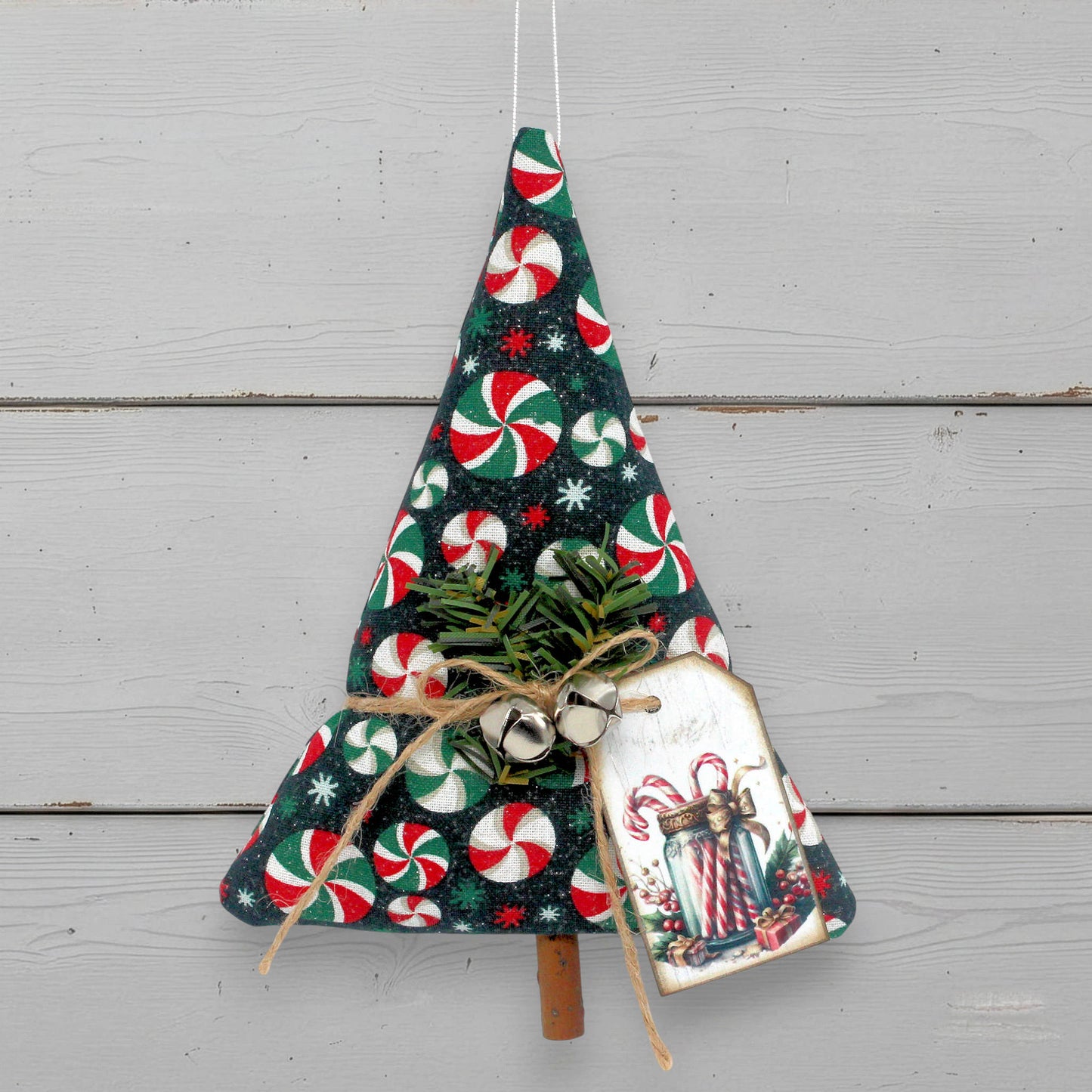 Decorative Christmas tree ornament with candy cane pattern on a white background