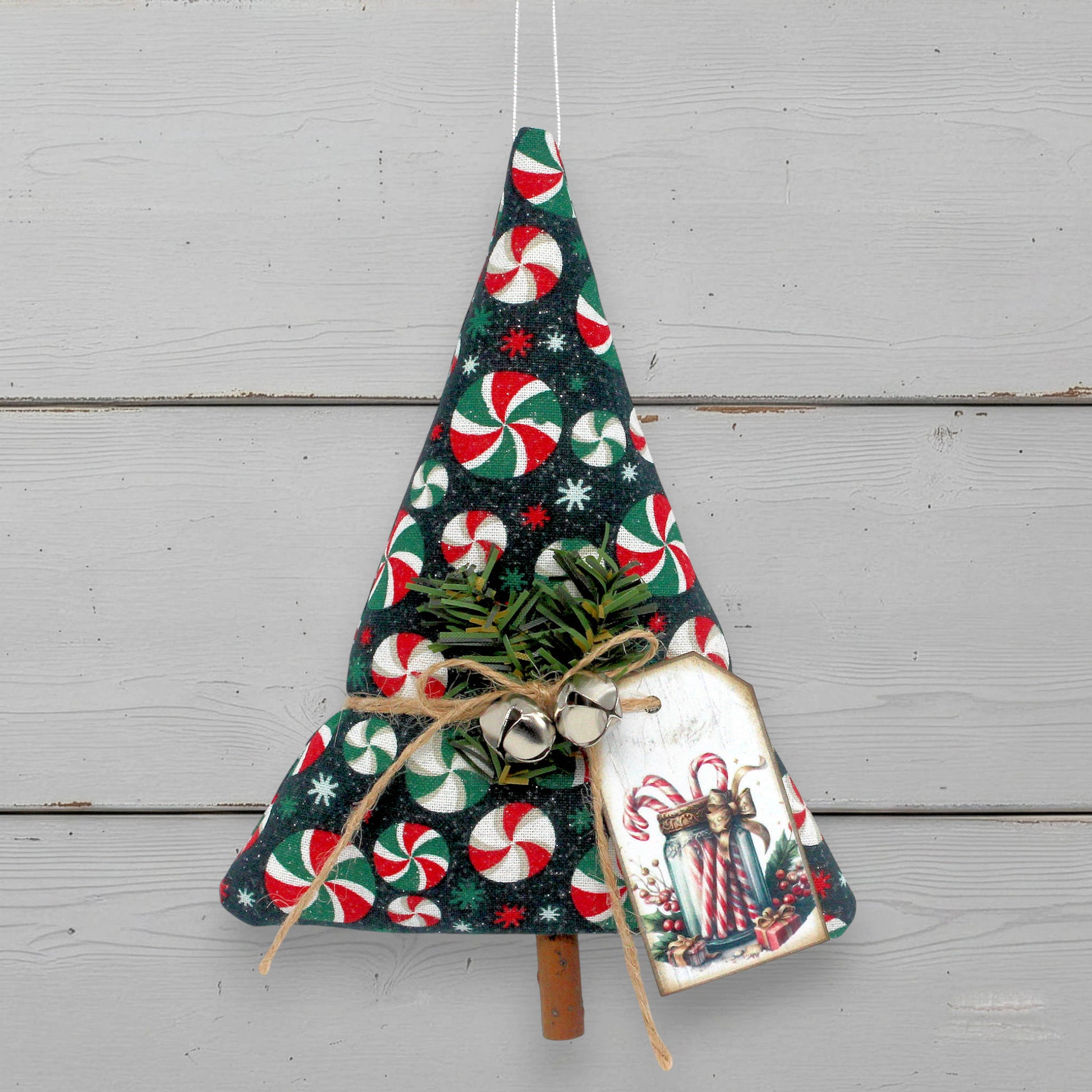 Decorative Christmas tree ornament with candy cane pattern on a white background