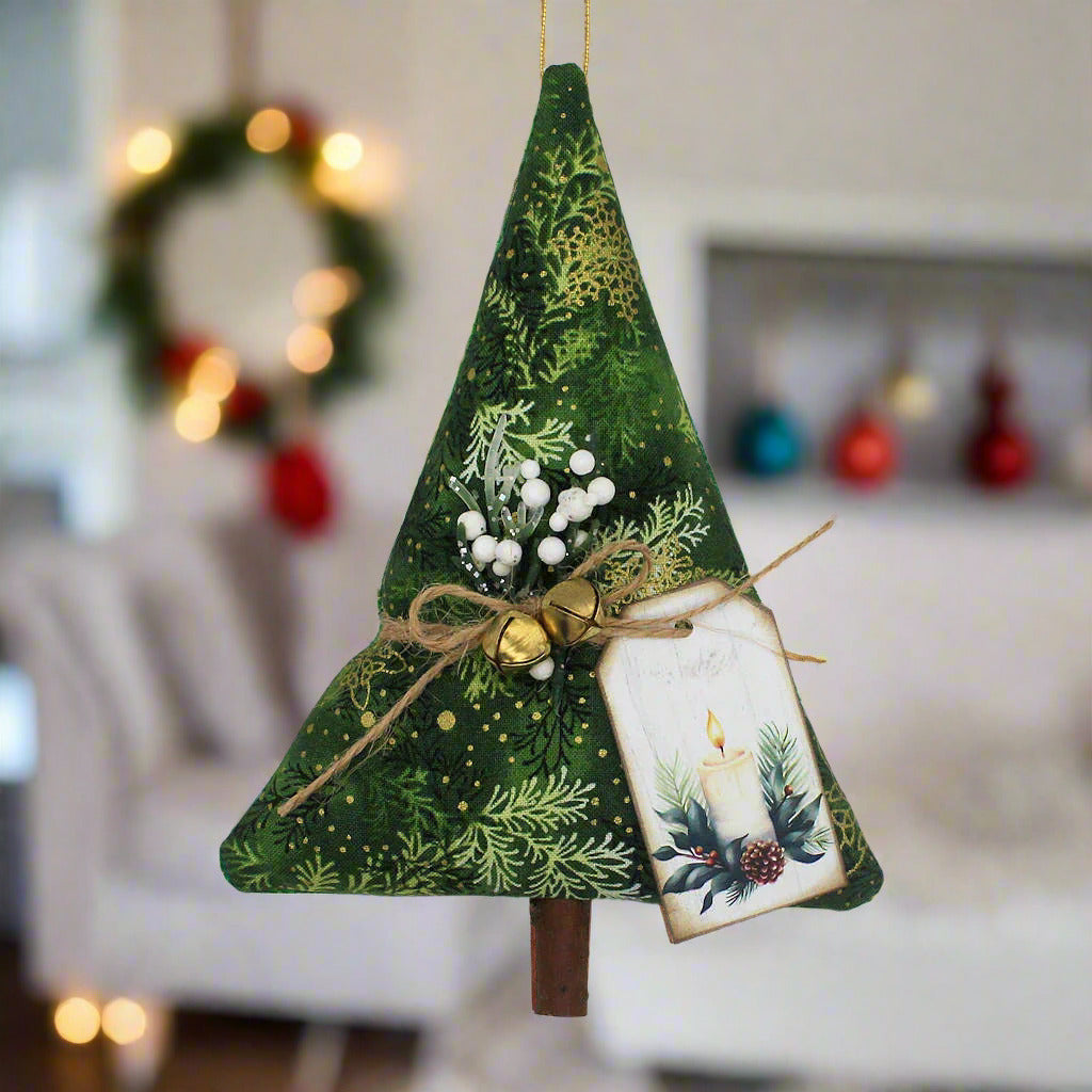 Decorative Christmas tree ornament with green fabric, gold jingle bells, and a small tag