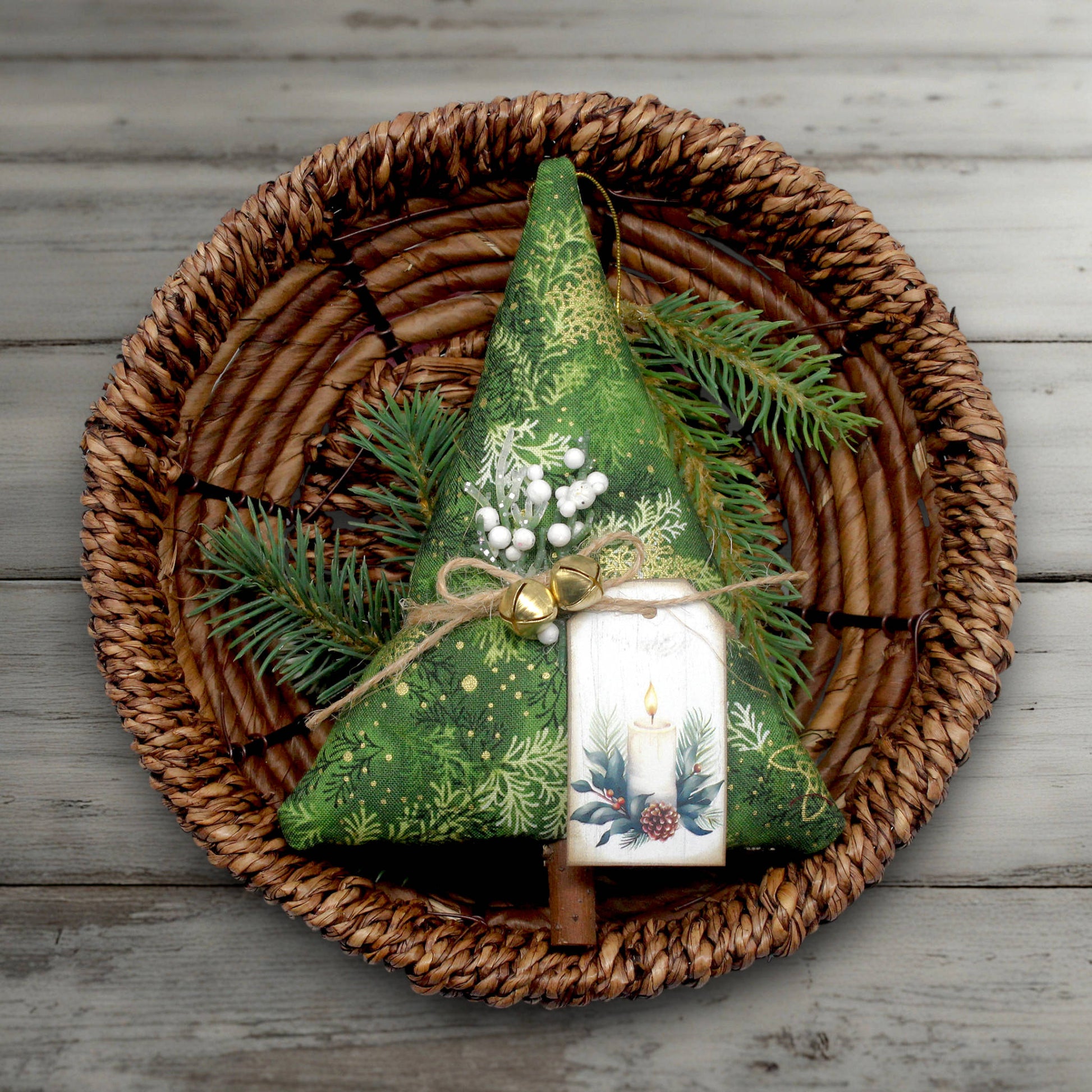 Christmas tree-shaped fabric ornament with greenery and a tag