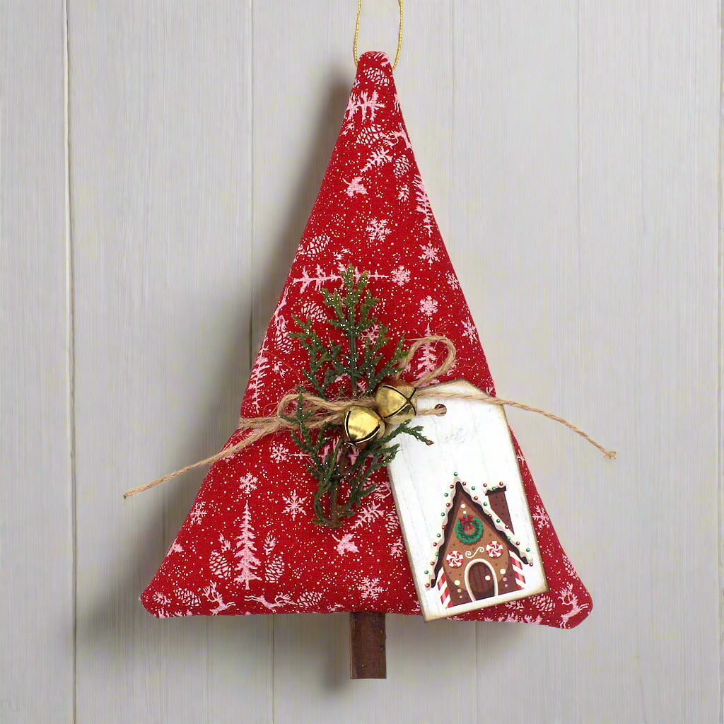 Red fabric Christmas tree ornament with greenery and a card on a white background