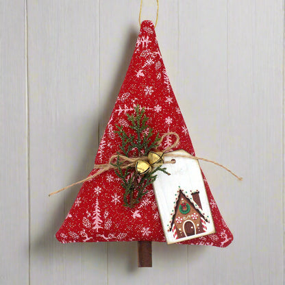 Red fabric Christmas tree ornament with greenery and a card on a white background