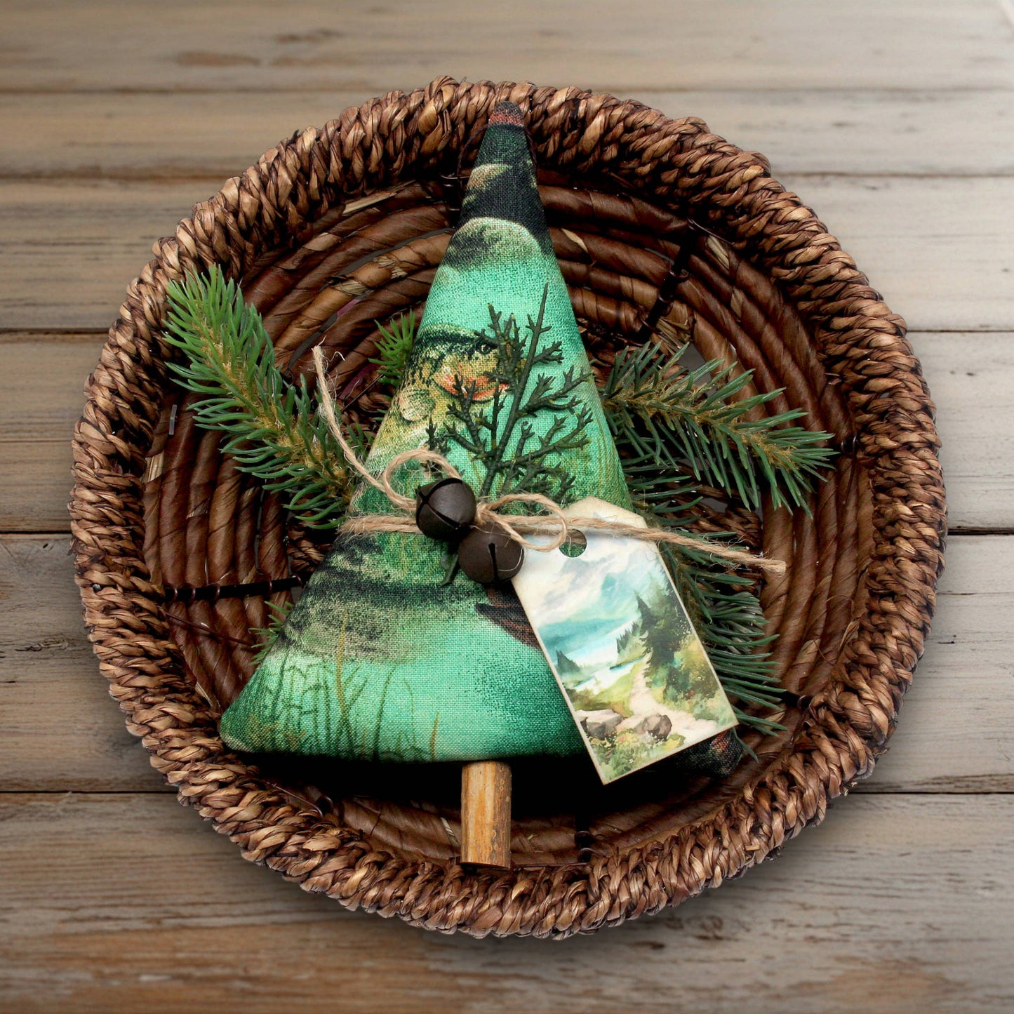Christmas tree-shaped ornament made from fabric with a nature fishing design