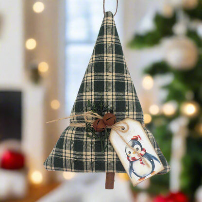Green homespun Christmas tree ornament or bowl filler with rusty bells, greenery and a penguin tag