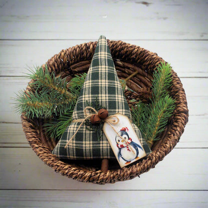 Decorative Christmas tree with plaid pattern in a woven basket with pine branches on a white background