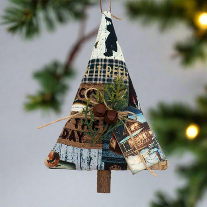 Tree-shaped ornament or bowl filler from a cotton print fabric with a fishing cabin design along with rusty bells, greenery and a tag