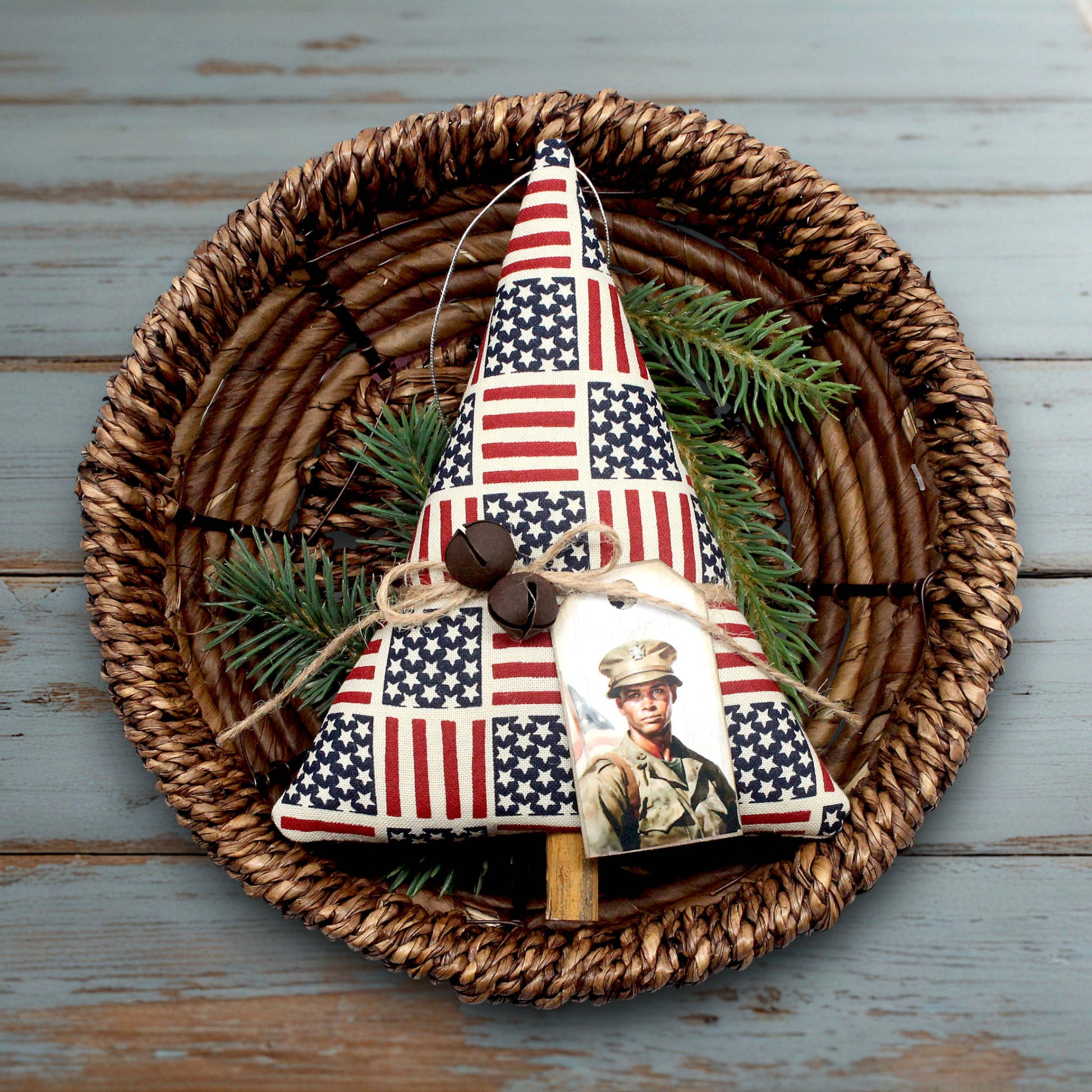 Decorative Christmas tree ornament with American flag pattern on a woven plate.