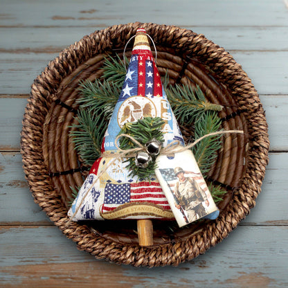 Decorative Christmas tree ornament with American flag design on a woven plate.