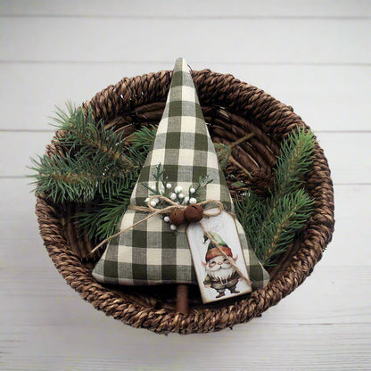 Decorative Christmas tree with plaid pattern in a woven basket with greenery on a white background