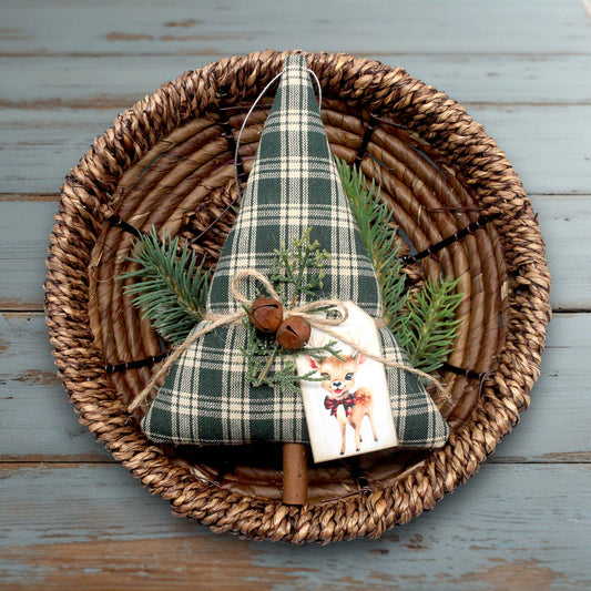 Decorative Christmas tree ornament with plaid pattern on a woven plate.