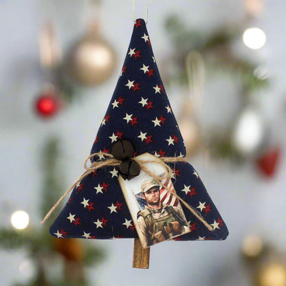 Tree-shaped Christmas ornament or bowl filler with red and white stars on a dark blue background, rusty bells and a tag