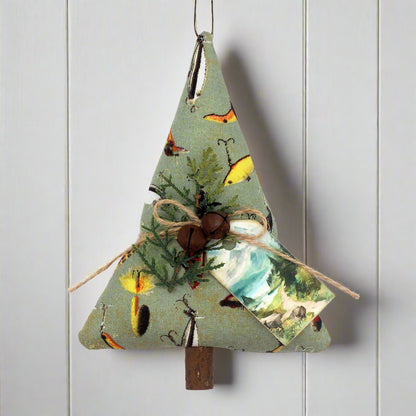 Decorative Christmas tree ornament with nature-themed fabric on a white background