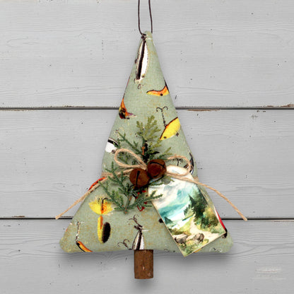 Decorative fabric tree with nature-themed print on a wooden surface