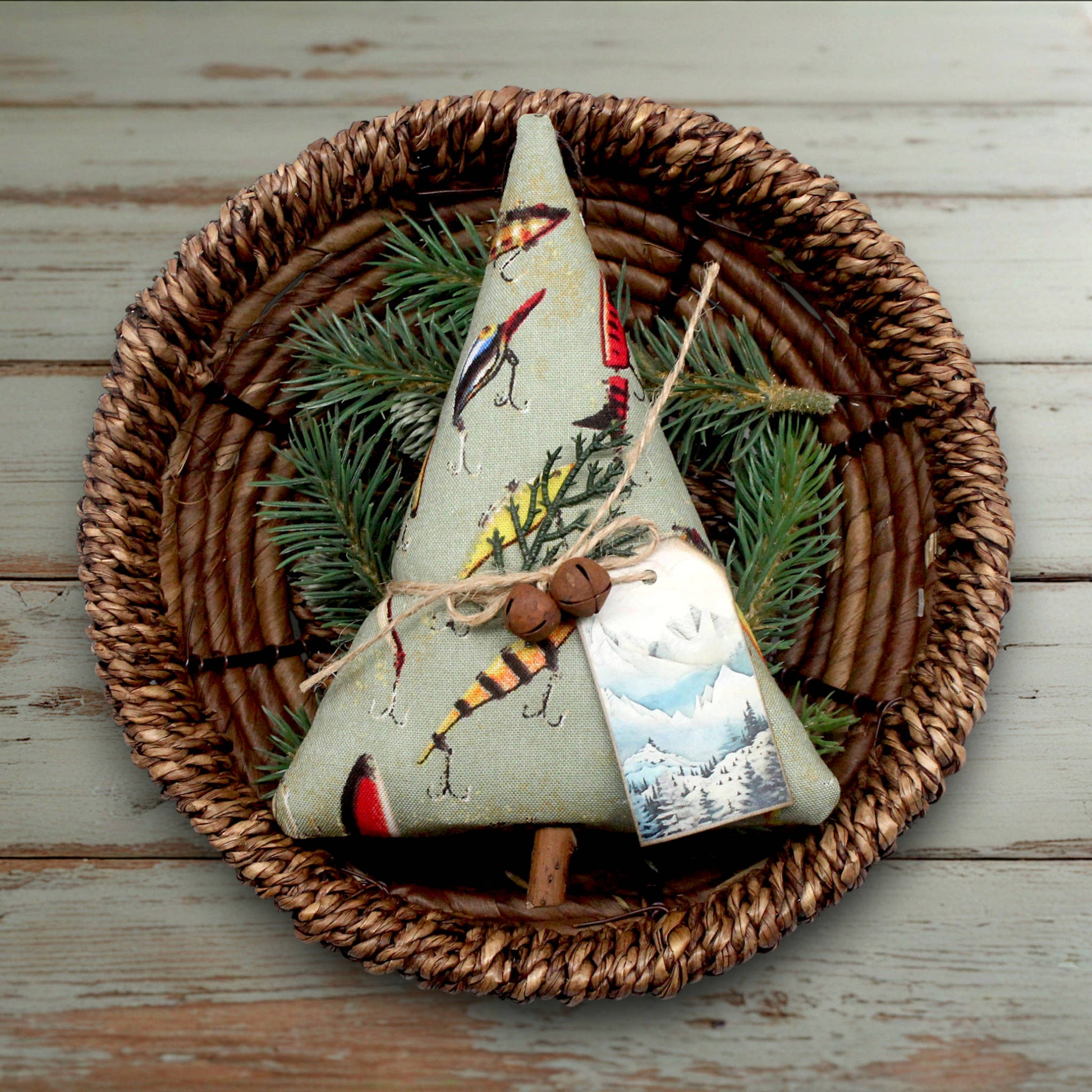 Decorative Christmas tree ornament with nature-themed design on a woven plate