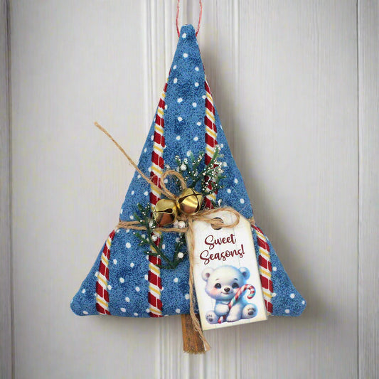 Decorative Christmas tree ornament with candy cane details and a tag on a white background