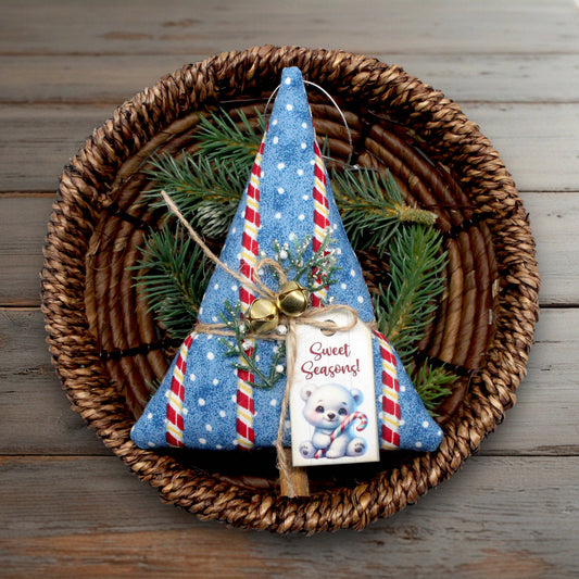 Decorative Christmas tree ornament with candy cane details on a woven basket with greenery