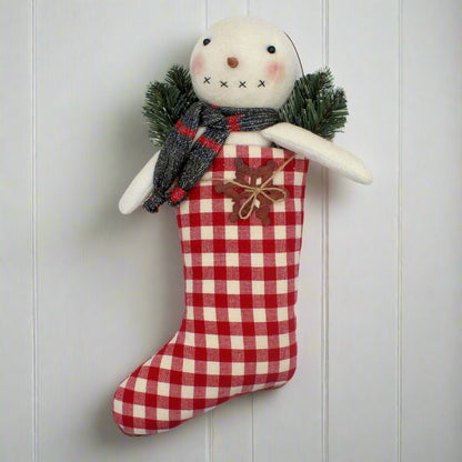 Primitive cotton batting snowman in a red and white homespun stocking with pine and a rusty snowflake