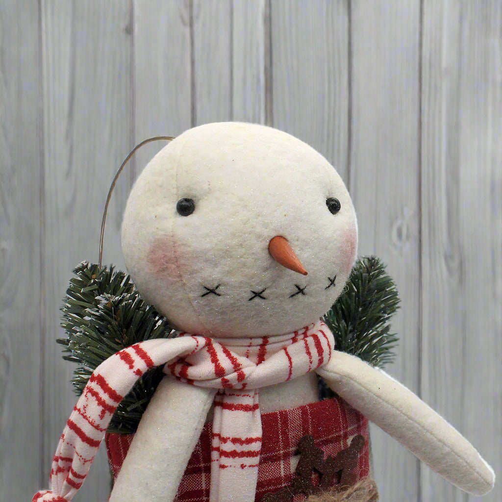 Primitive handmade snowman in a red and white homespun stocking
