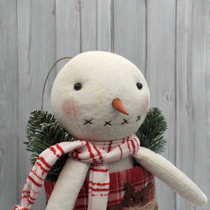 Primitive handmade snowman in a red and white homespun stocking