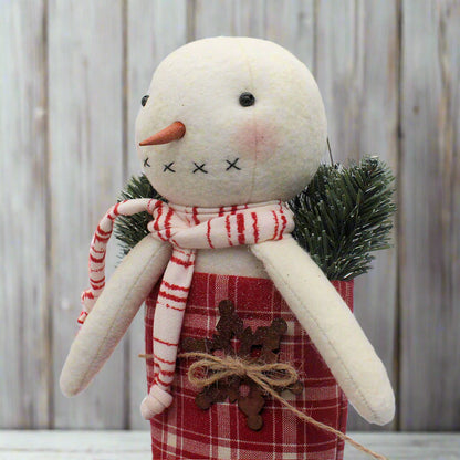Handmade primitive snowman in a red and white homespun stocking